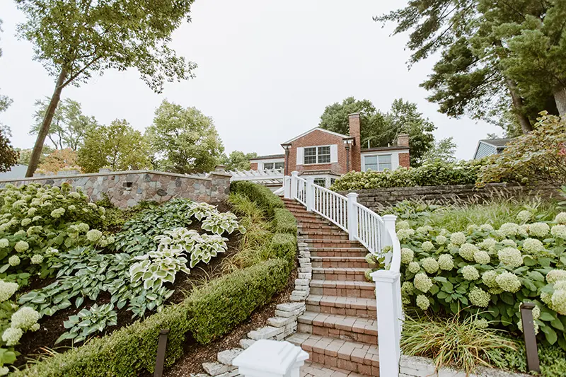 A beautifully tiered landscape with stone steps and well-groomed plants